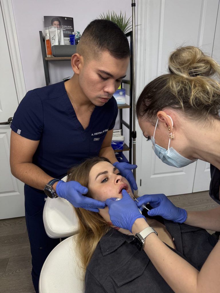 Nurse injector students treating a live model during advanced training at Beauty Maison Aesthetics