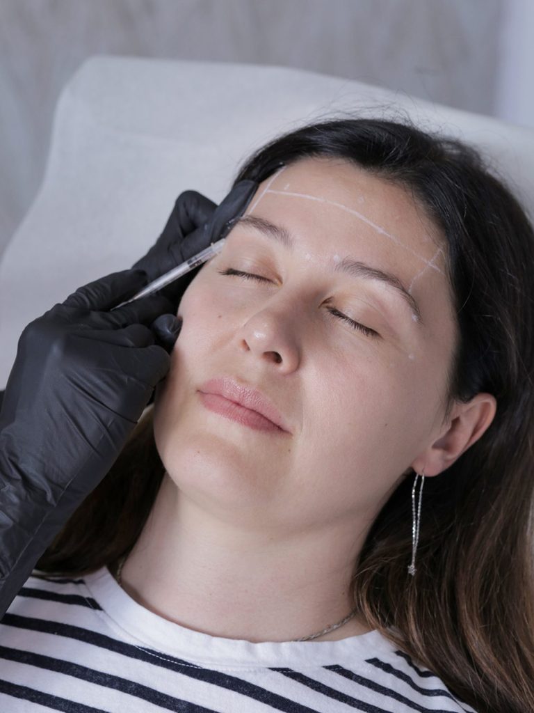 Injection near the temple and brow during treatment at a Vaughan clinic