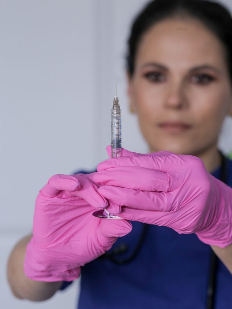 Nurse holding a microneedling device used for the vampire facial